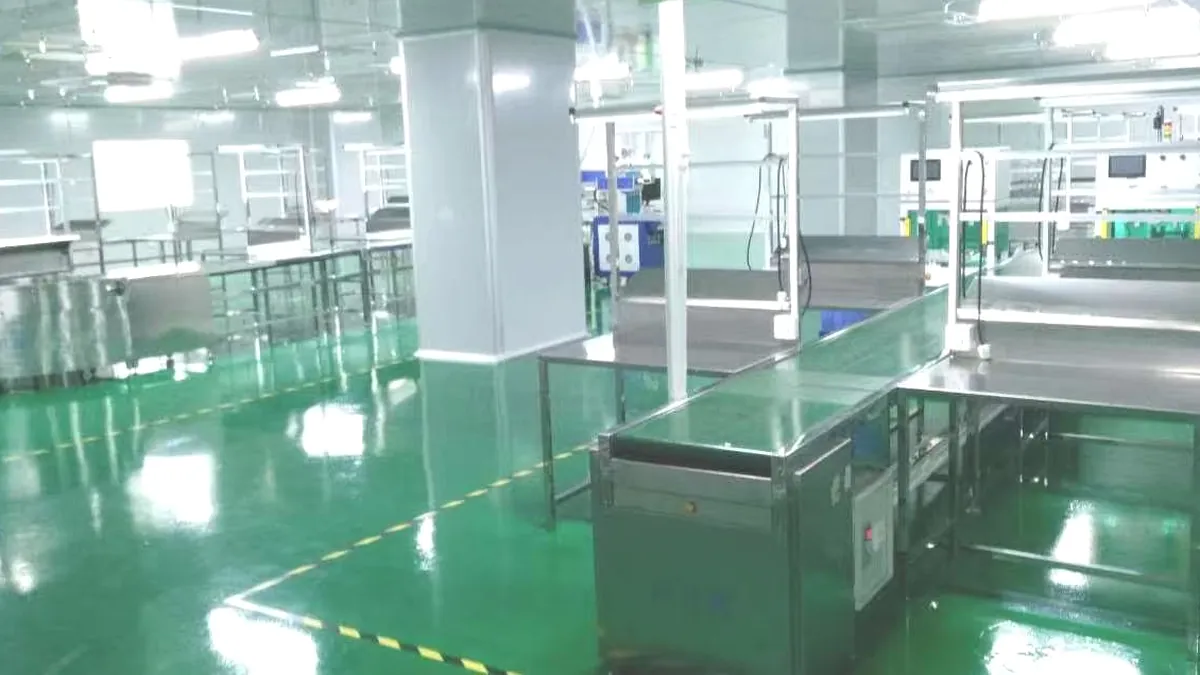 Clean assembly area with worktables and green floor