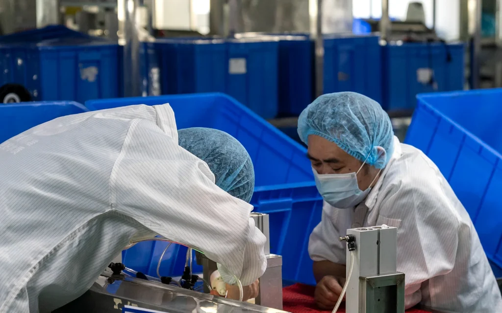 Functional testing station with technicians working on water filtration components